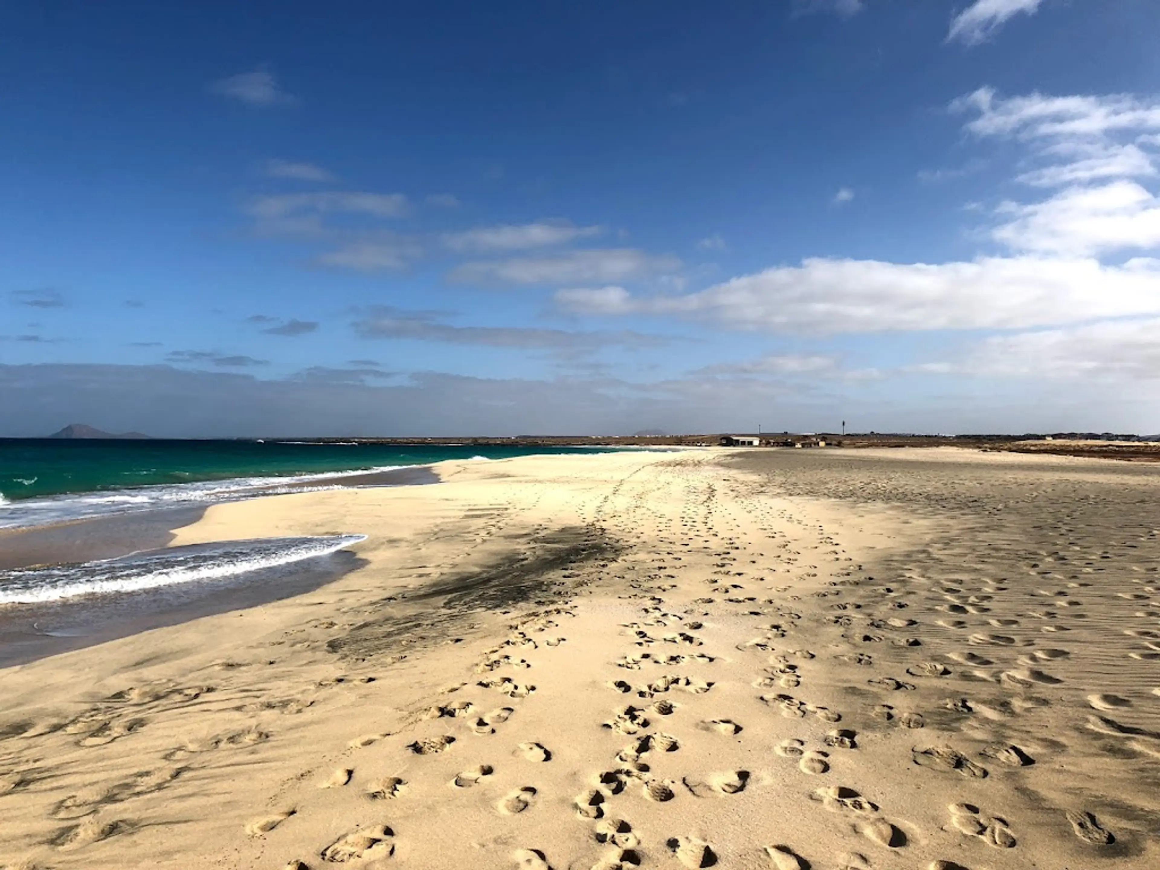 Sand dunes and palm-fringed beaches