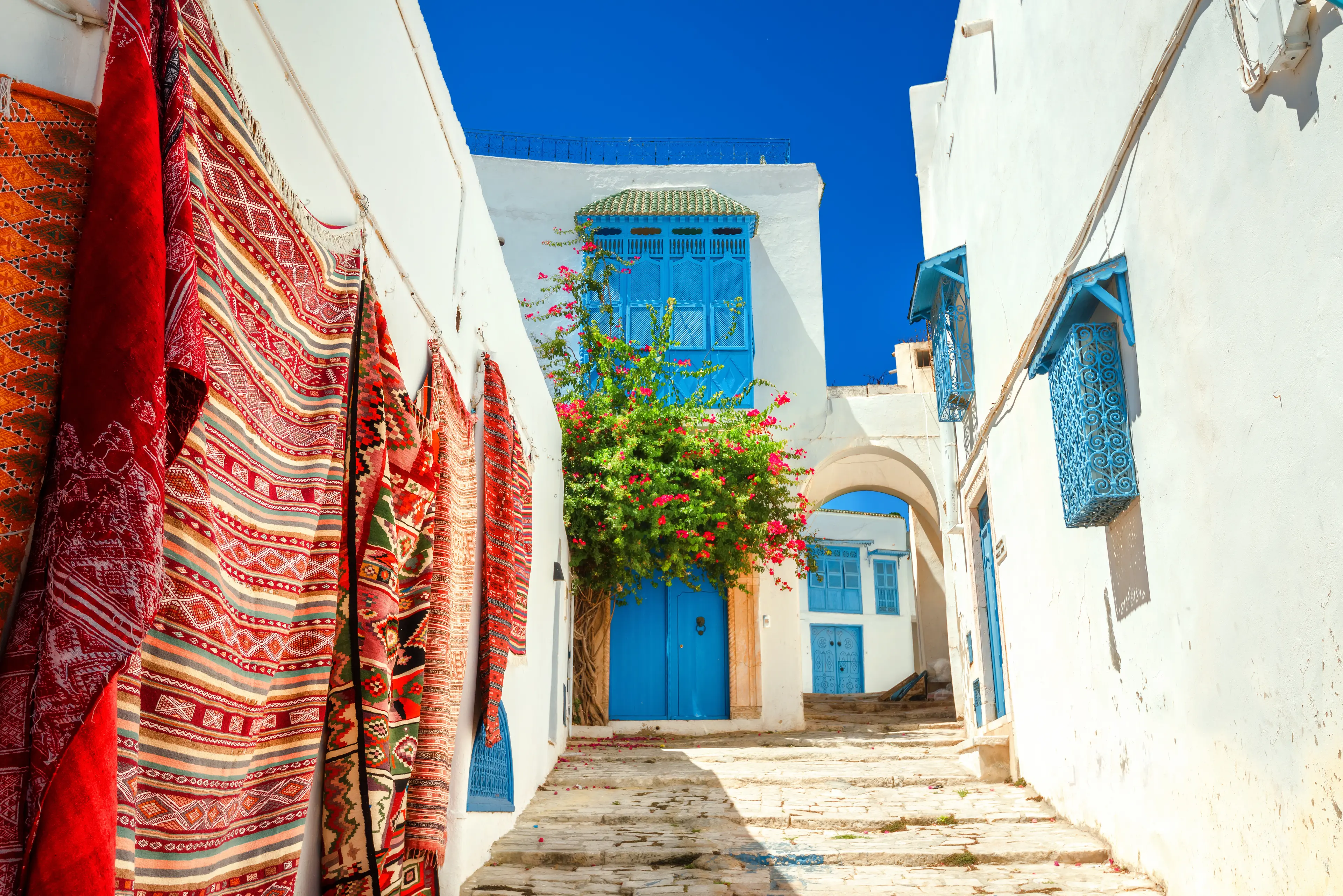 Whitewashed houses with colorful carpets