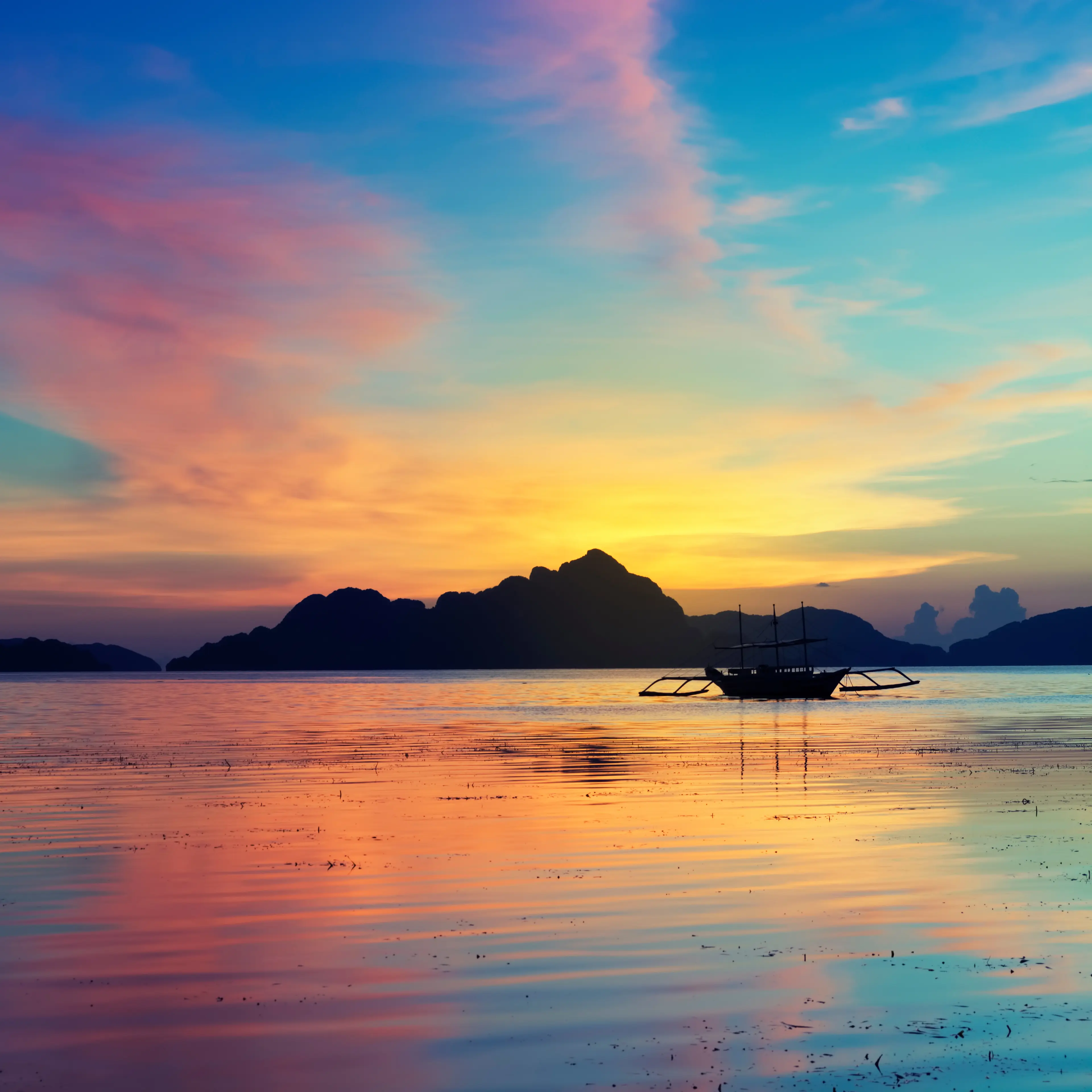 Tropical sunset with a banca boat Tropical sunset with a banca boat