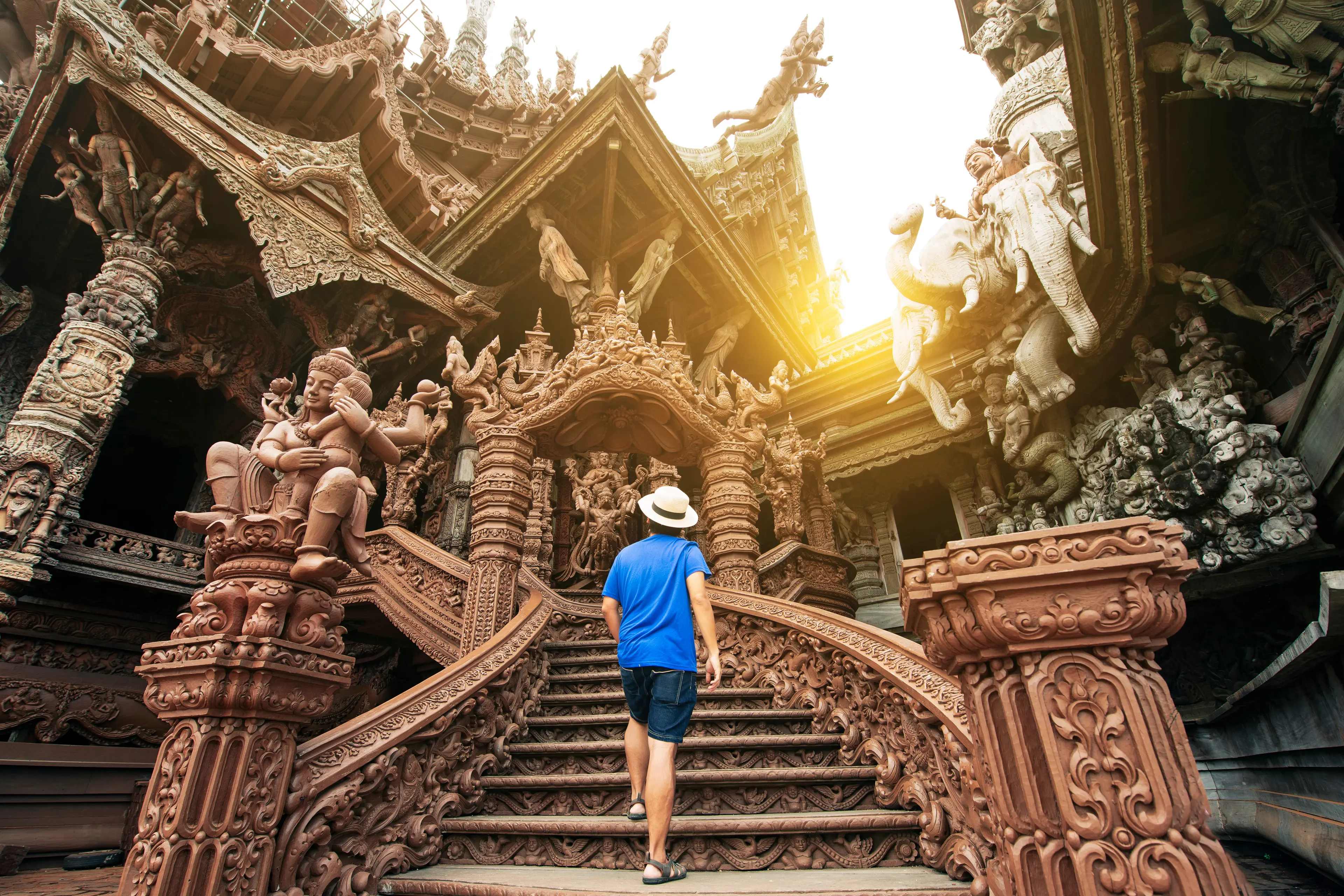 A tourist climbing up the stairs of the Sanctuary of Truth