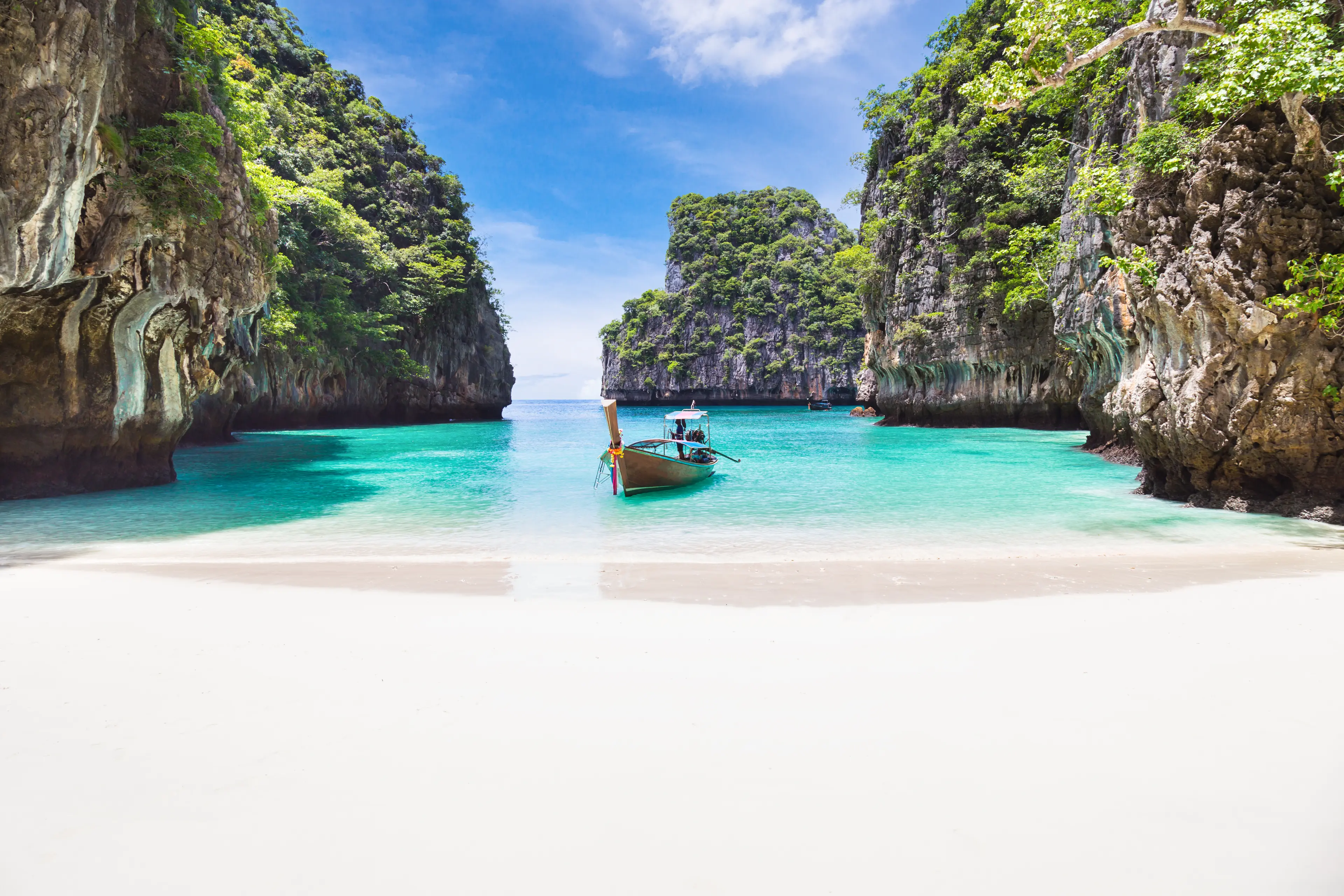 Thai traditional wooden longtail boat and beautiful beach