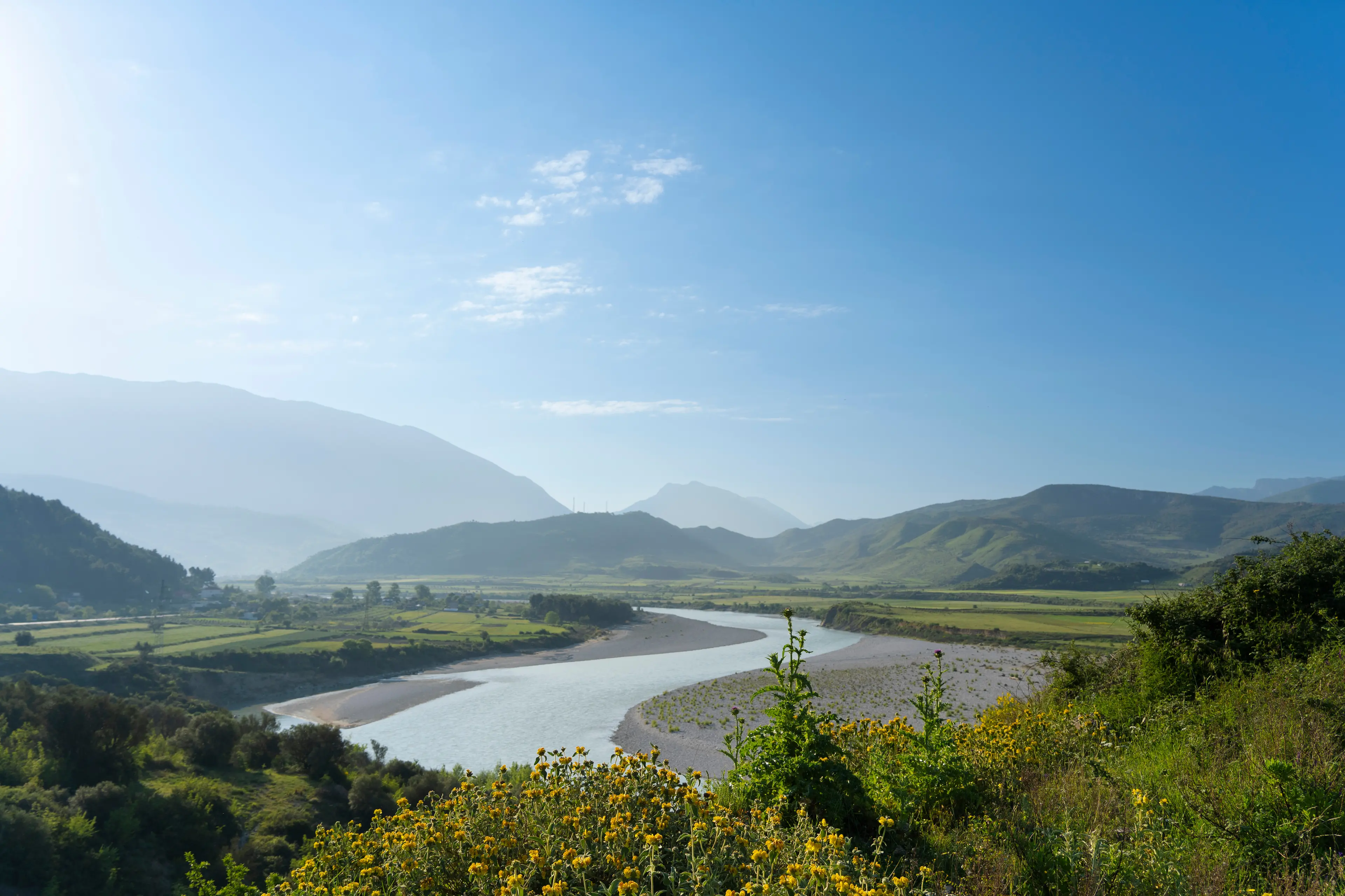 Vjosa wild river, national park, in blue sky sunrise.