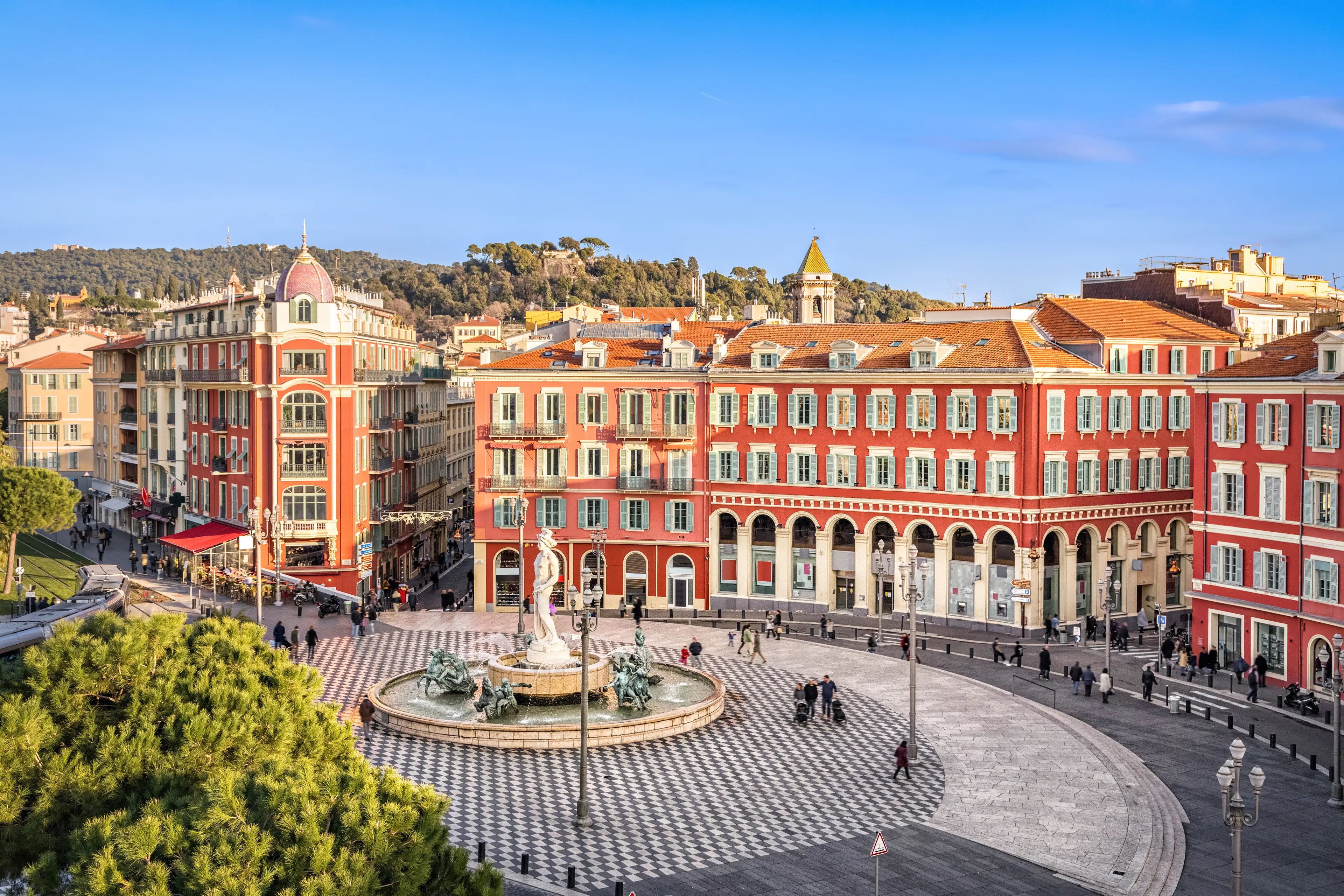 Place Massena square with red buildings and fountain Place Massena square with red buildings and fountain