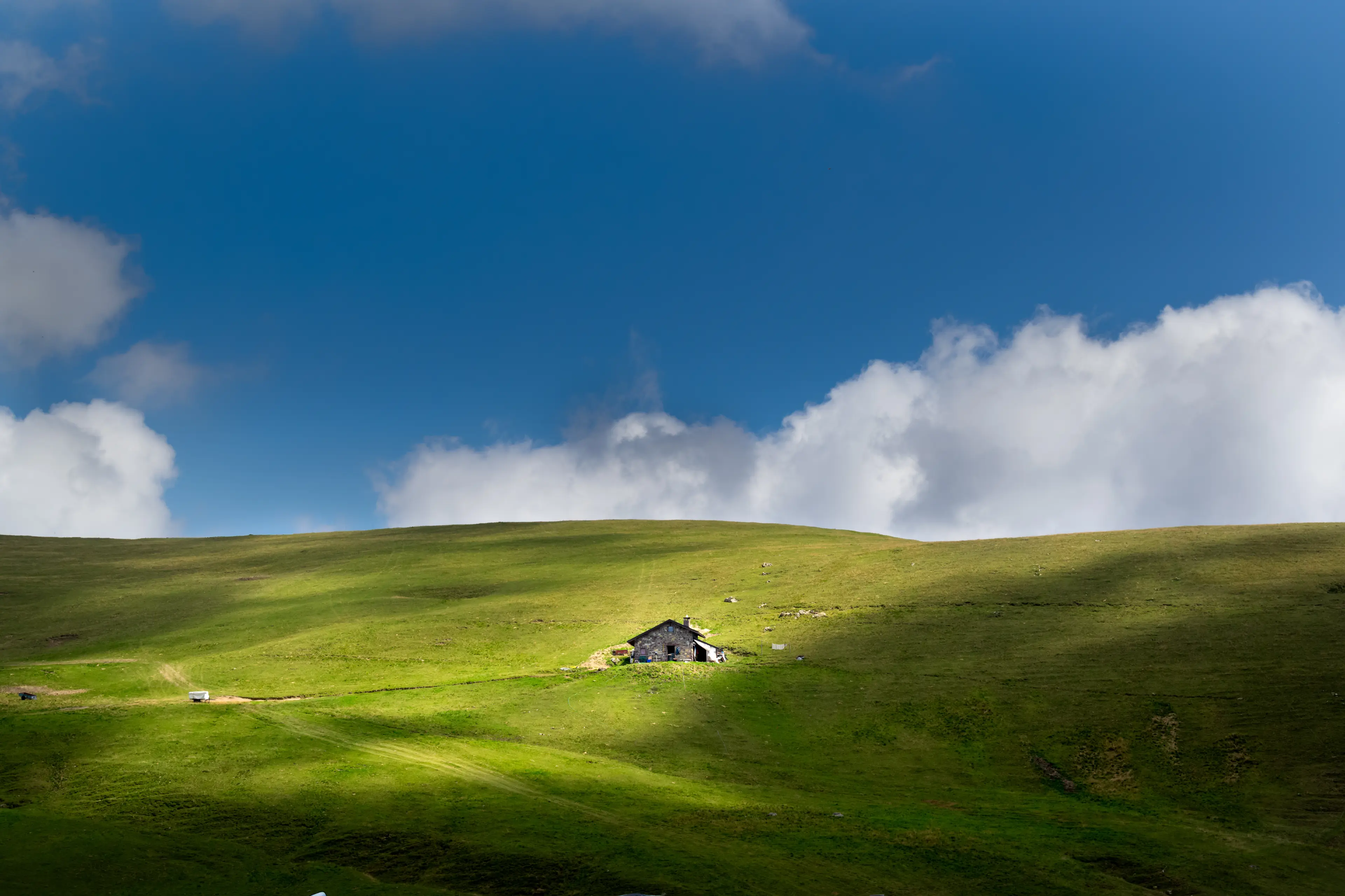 Grassy hill with an isolated cabin, the Piani dell'Avaro, Val Brembana