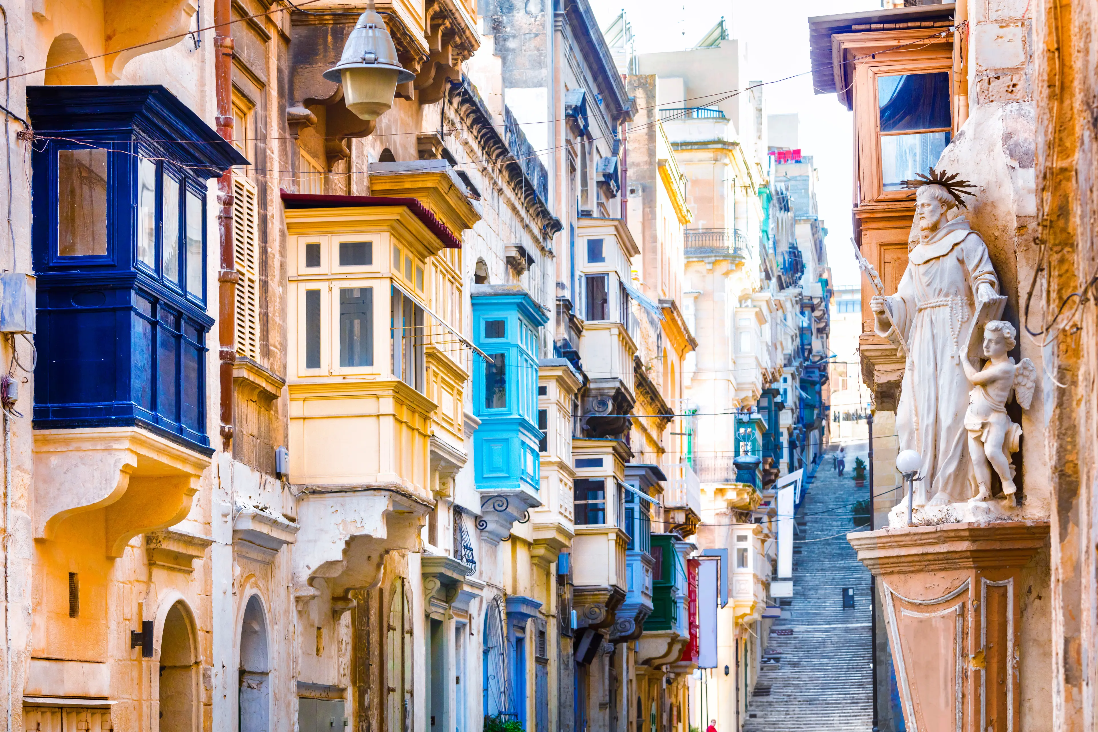 Narrow street with typical Maltese architecture