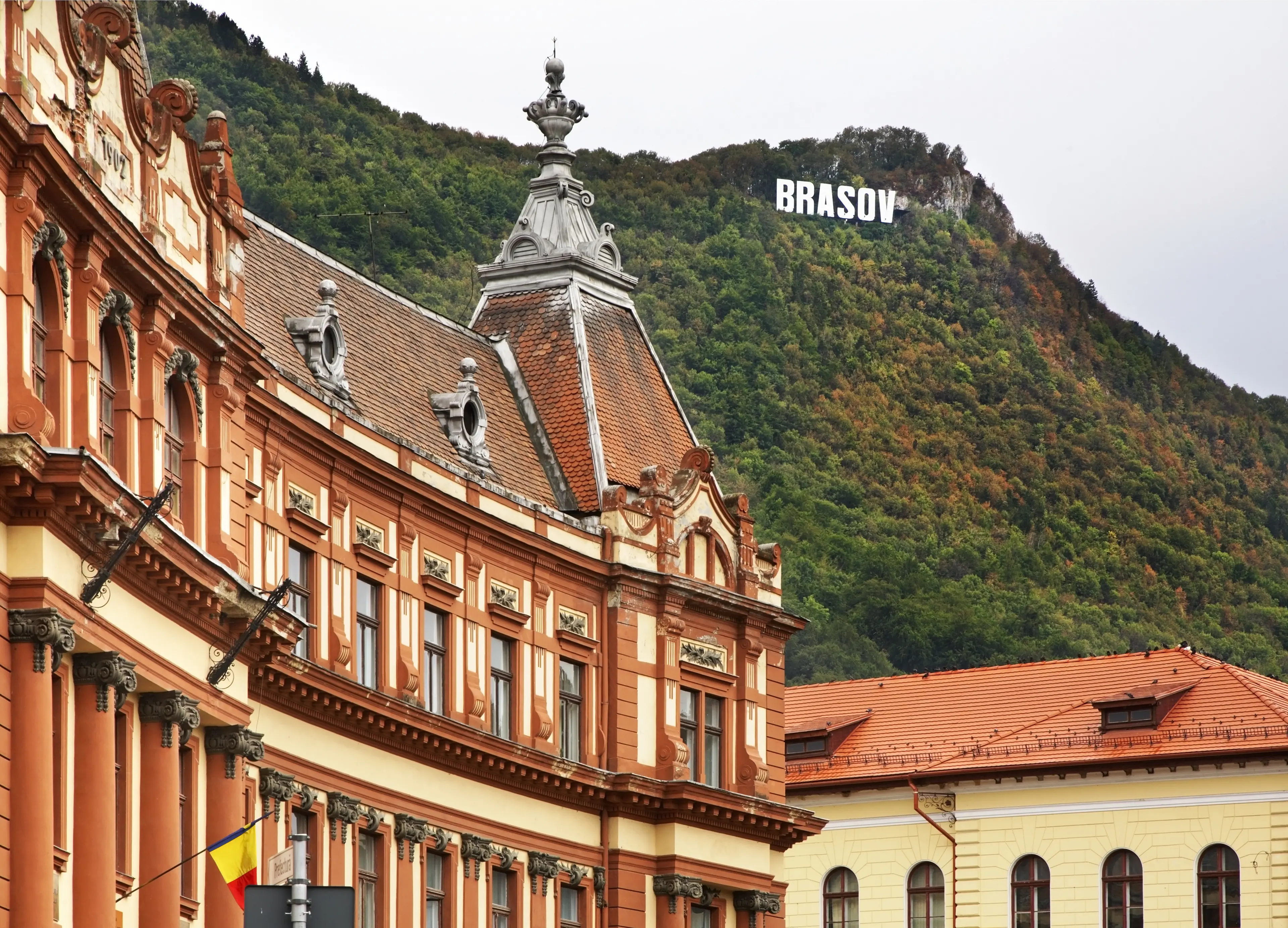 Council of Brasov County with hilltop city sign