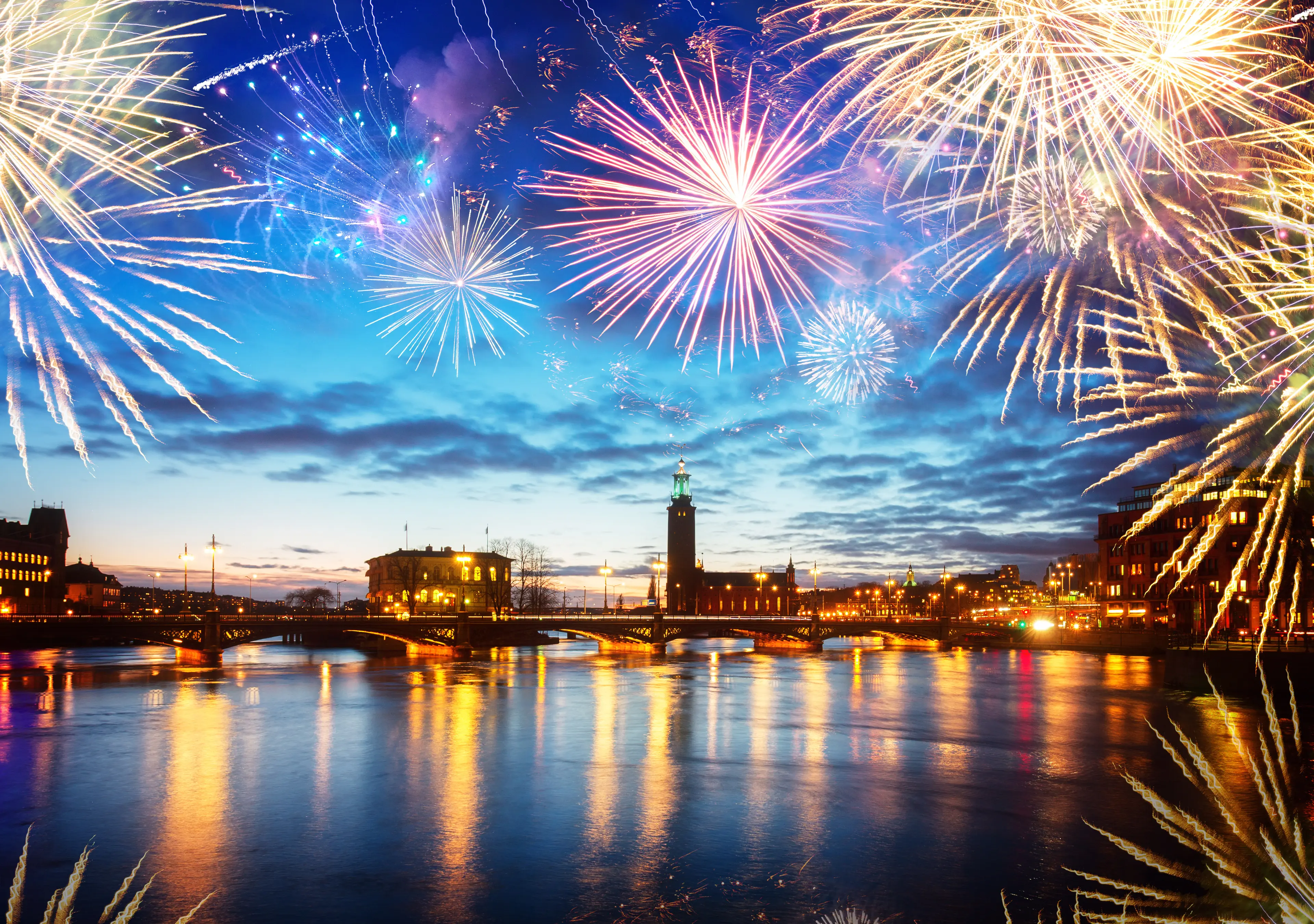 skyline and city hall of Stockholm at night with fiewworks,