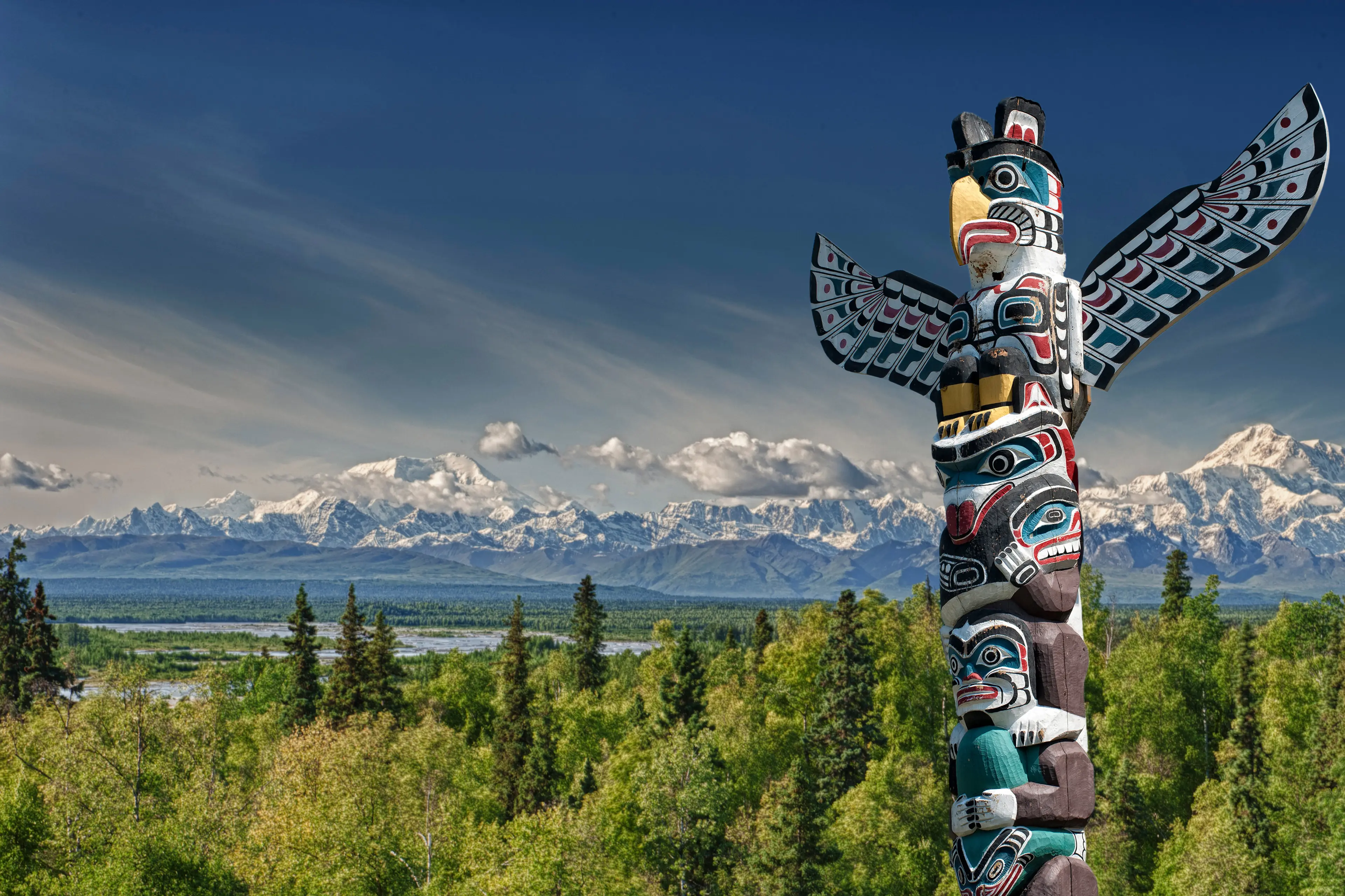 Mountain landscape with wooden totem pole 