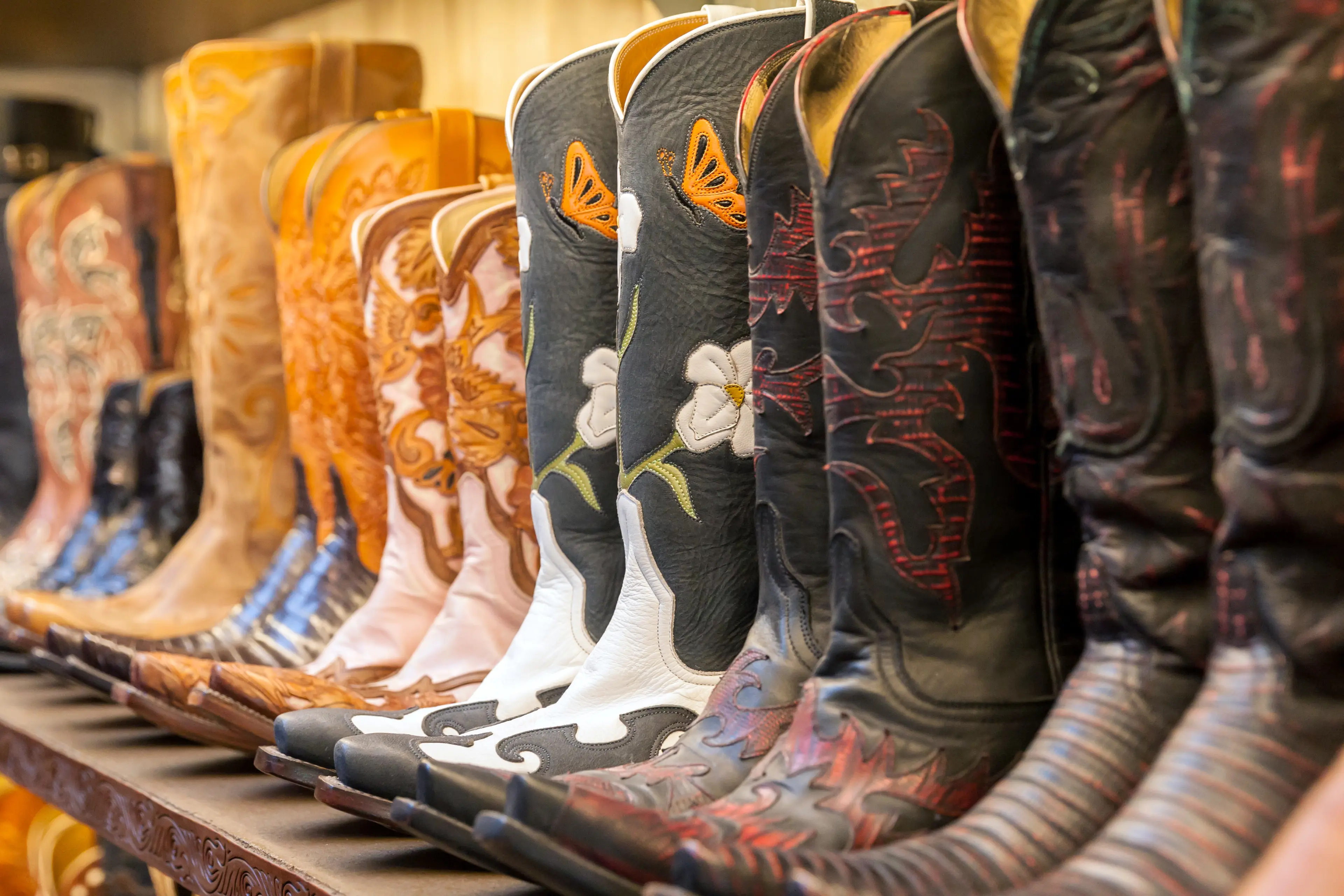 Cowboy boots aligned on a store shelf